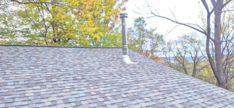 Finished architectural shingle roof with a Class A chimney pipe and storm collar