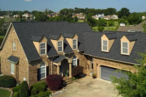Brick home finished in dark architectural asphalt shingles
