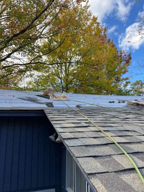 Roof replacement in progress with synthetic underlayment down and shingles going on